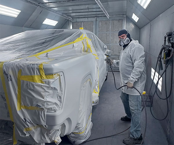 Collision repair technician in spraybooth